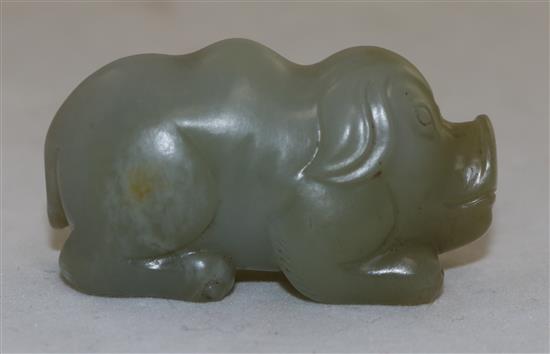 A Chinese pale celadon jade figure of a recumbent pig, 19th century, 5.6cm